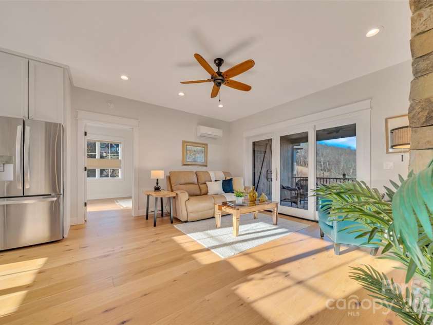 23 Thunder Mountain Road, Hendersonville, NC 28792.  MLS# CAR4213097, YatesRealty ID 21895. Guest wing with living room, stacked stone fireplace and kitchen