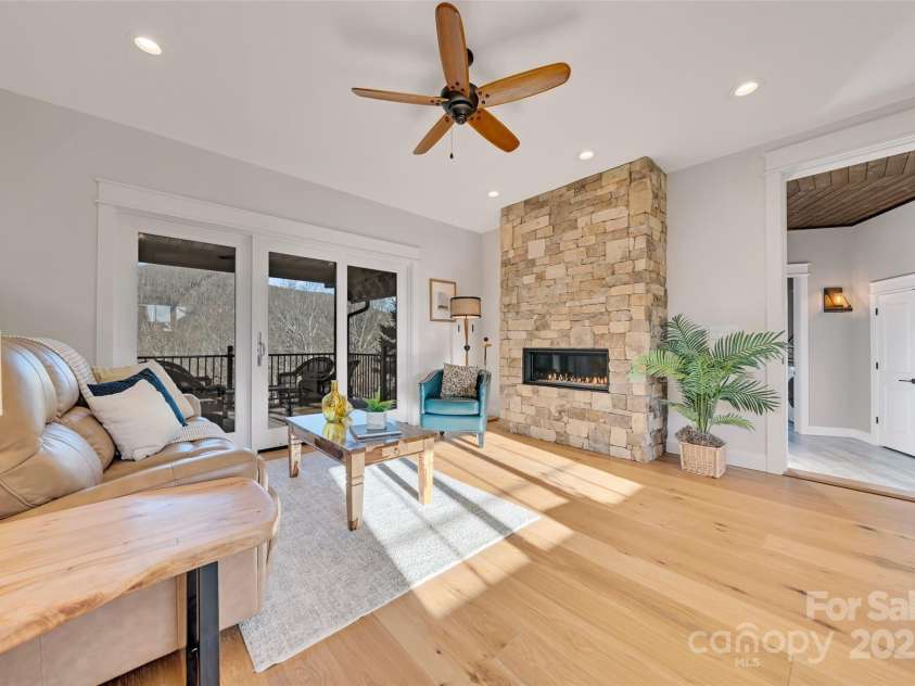 23 Thunder Mountain Road, Hendersonville, NC 28792.  MLS# CAR4213097, YatesRealty ID 21895. Guest wing with living room, stacked stone fireplace and kitchen