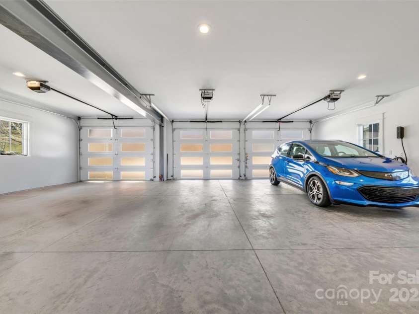 23 Thunder Mountain Road, Hendersonville, NC 28792.  MLS# CAR4213097, YatesRealty ID 21895. Large 3-car garage, steel beam construction, with EV charger