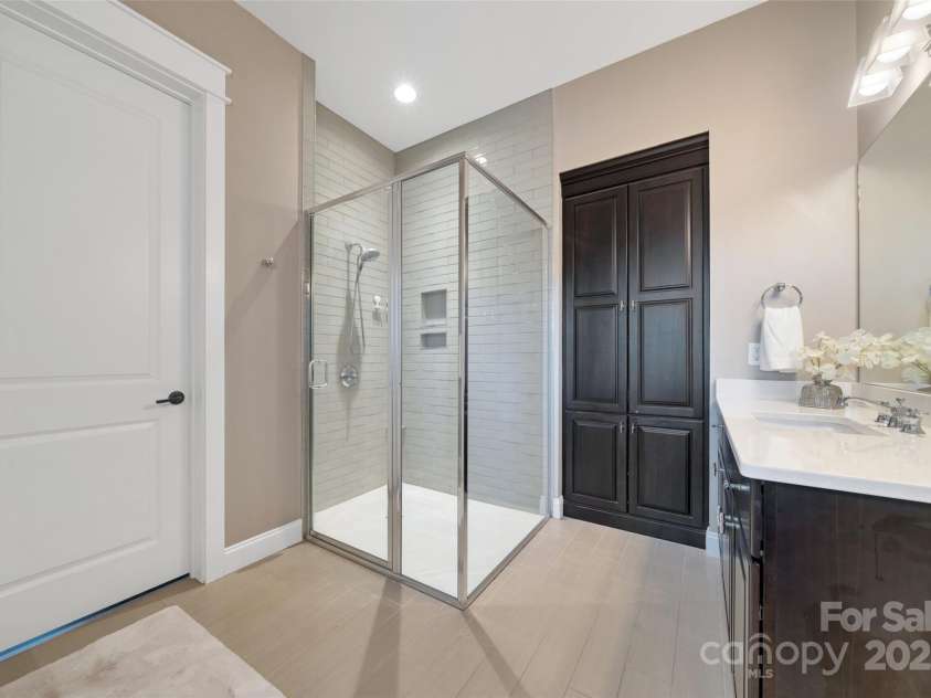 23 Thunder Mountain Road, Hendersonville, NC 28792.  MLS# CAR4213097, YatesRealty ID 21895. Primary bathroom with two vanities, shower, and walk in closet