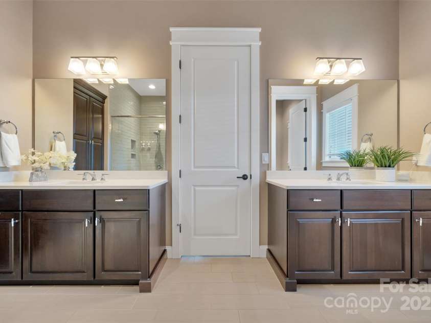 23 Thunder Mountain Road, Hendersonville, NC 28792.  MLS# CAR4213097, YatesRealty ID 21895. Primary bathroom with two vanities, shower, and walk in closet