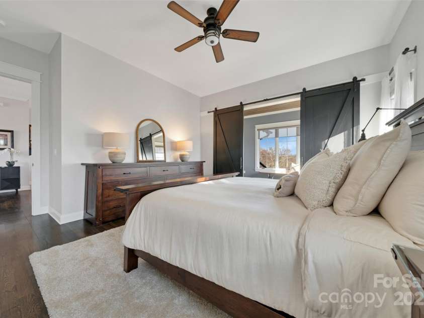 23 Thunder Mountain Road, Hendersonville, NC 28792.  MLS# CAR4213097, YatesRealty ID 21895. Spacious primary bedroom with ensuite bathroom and sunlit sitting room/office with private entrance to the main deck.