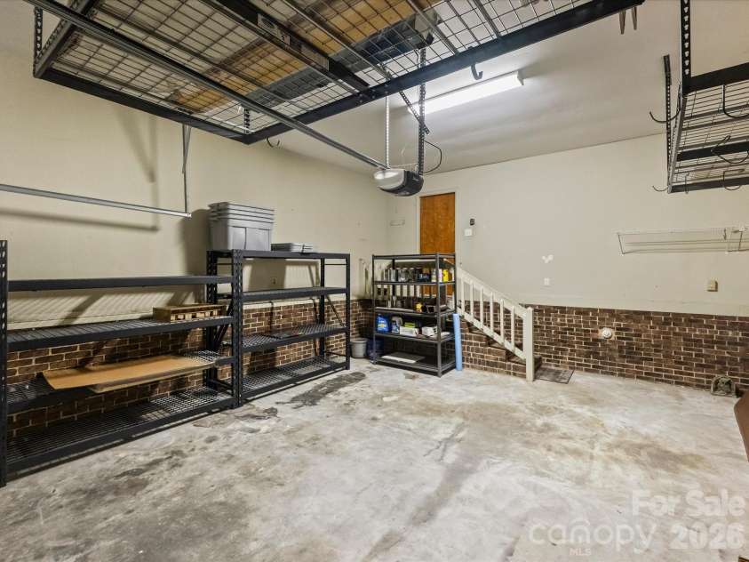 6434 Brandonwood Court, Charlotte, NC 28226.  MLS# CAR4380490, YatesRealty ID 21919. Two-car garage with industrial storage racks
