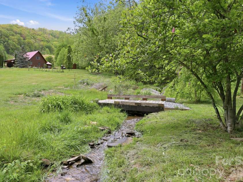 2225 Bald Creek Road, Clyde, NC 28721.  MLS# CAR4375884, YatesRealty ID 21920. Small stream that runs thru the property