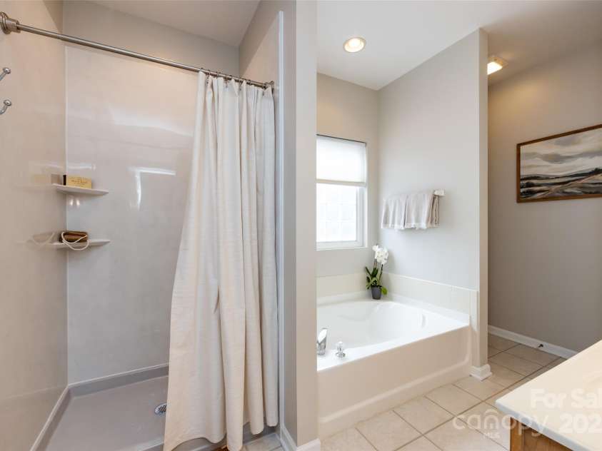 1040 Stonedown Lane, Matthews, NC 28104.  MLS# CAR4271671, YatesRealty ID 21926. Recently updated shower in primary ensuite