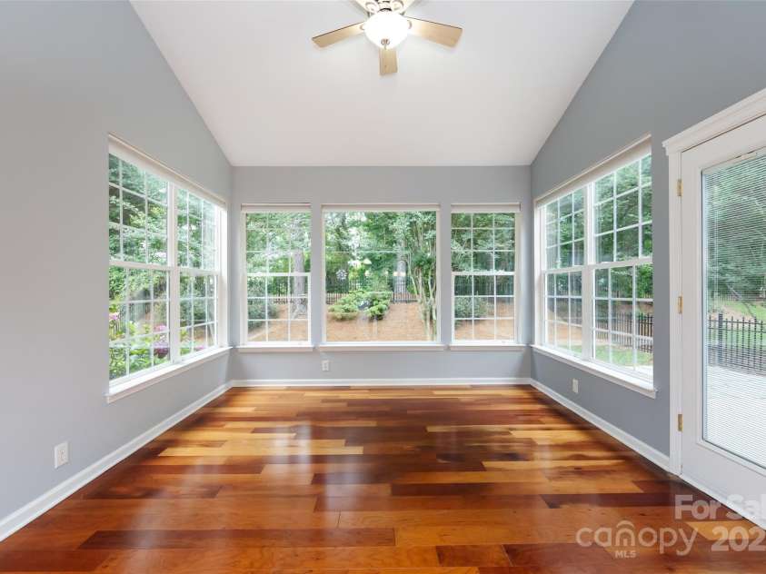 1040 Stonedown Lane, Matthews, NC 28104.  MLS# CAR4271671, YatesRealty ID 21926. Sunroom has three walls of windows!