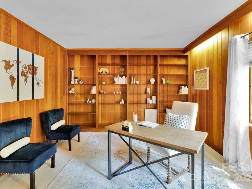 331 Glen Oaks Road, Charlotte, NC 28270.  MLS# CAR4260350, YatesRealty ID 21929. Wall to ceiling adjustable shelving. Large windows give a nice contrast to the original wood paneled walls creating a 
