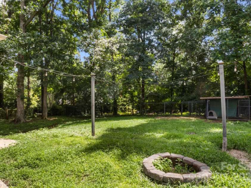 1210 Brookwood Drive, Shelby, NC 28150.  MLS# CAR4229216, YatesRealty ID 21944. Great outdoor area with fire pit and cafe lights