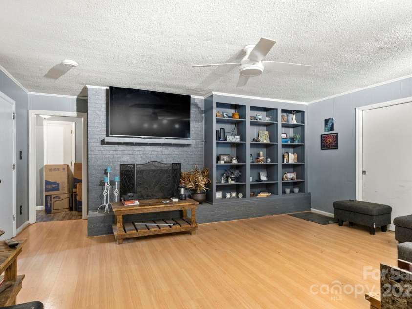 1210 Brookwood Drive, Shelby, NC 28150.  MLS# CAR4229216, YatesRealty ID 21944. The den offers a painted brick hearth and built-ins.