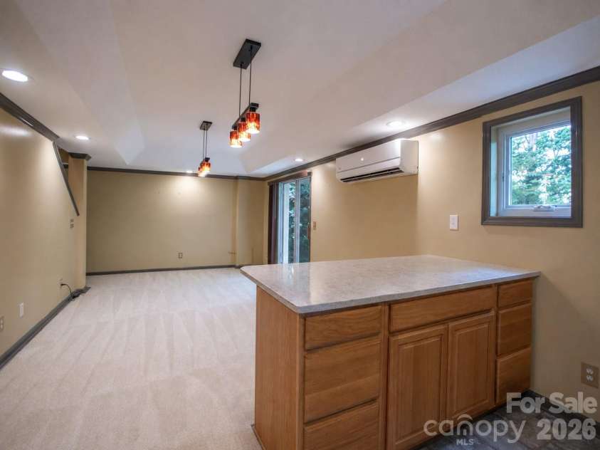1002 Windsor Drive, Asheville, NC 28803.  MLS# CAR4413516, YatesRealty ID 21960. Lower level living area