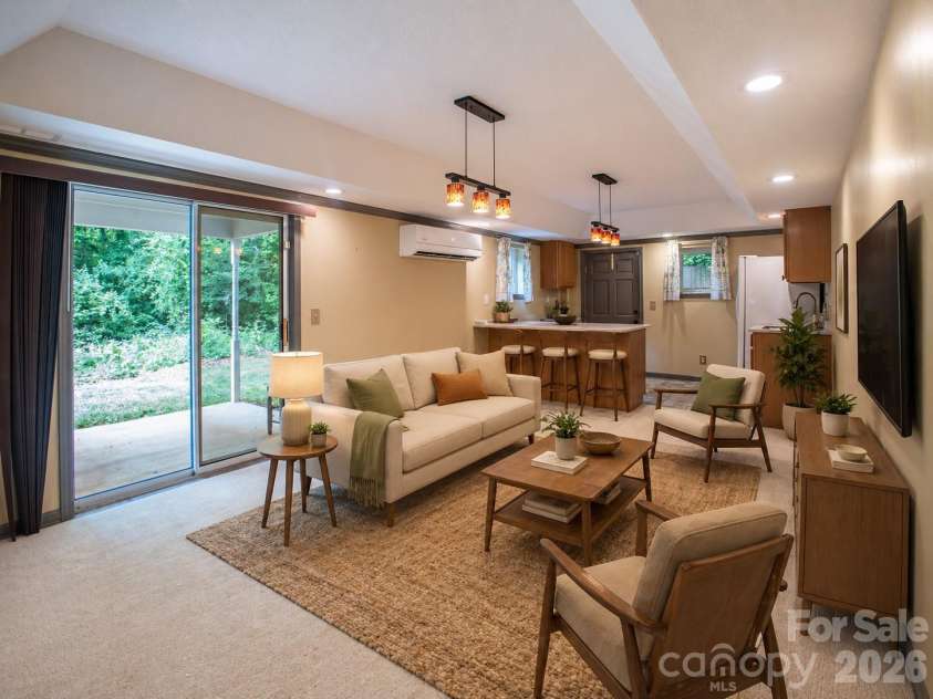 1002 Windsor Drive, Asheville, NC 28803.  MLS# CAR4413516, YatesRealty ID 21960. Staged lower level living area