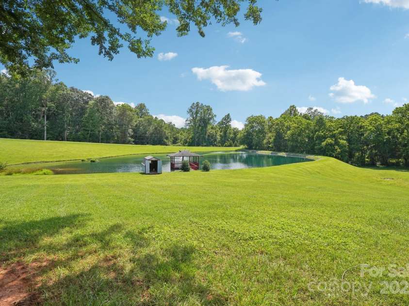 3381 Elaine Avenue, Lincolnton, NC 28092.  MLS# CAR4274962, YatesRealty ID 21964. Front yard with pond