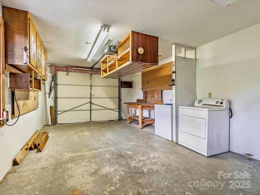 287 Sara Ridge Road, Waynesville, NC 28786.  MLS# CAR4260530, YatesRealty ID 21997. Basement workshop (garage door disabled)