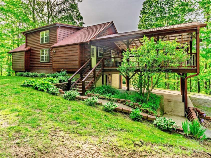 287 Sara Ridge Road, Waynesville, NC 28786.  MLS# CAR4260530, YatesRealty ID 21997. Elegant landscaping at the entrance