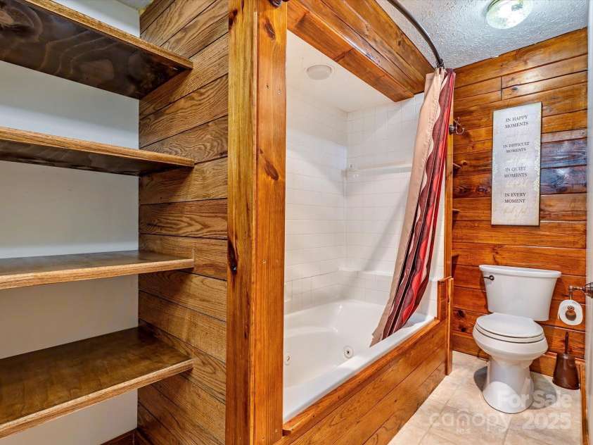 287 Sara Ridge Road, Waynesville, NC 28786.  MLS# CAR4260530, YatesRealty ID 21997. Jetted tub and open linen shelves in the primary bathroom
