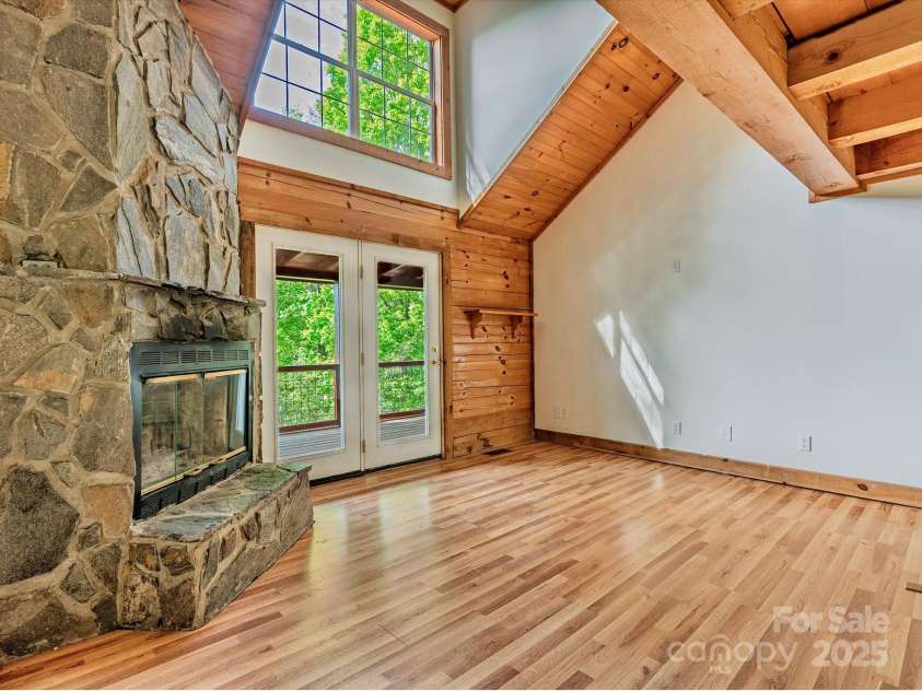 287 Sara Ridge Road, Waynesville, NC 28786.  MLS# CAR4260530, YatesRealty ID 21997. Rustic stone fireplace ready for cozy nights in the mountains