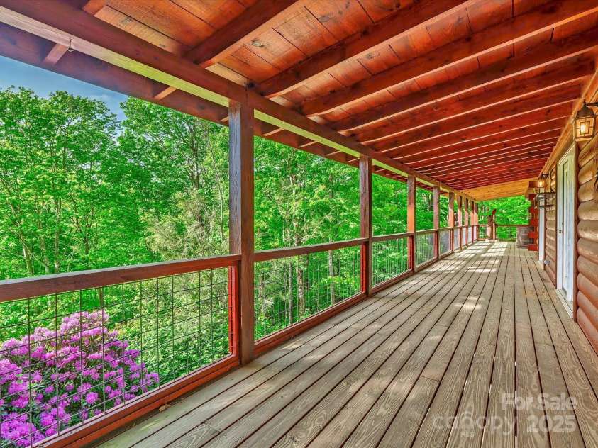 287 Sara Ridge Road, Waynesville, NC 28786.  MLS# CAR4260530, YatesRealty ID 21997. The porch extends to the front of the house, with multiple exterior entrances