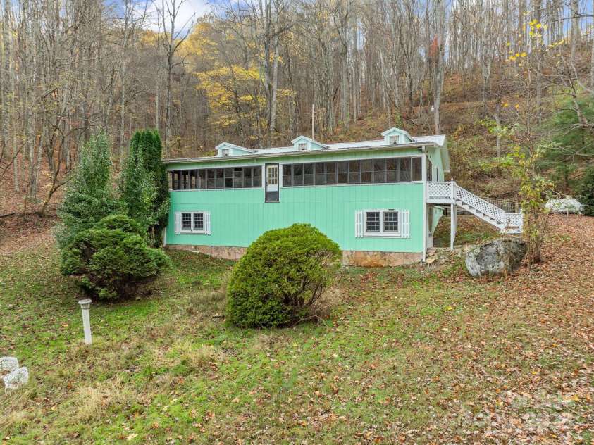 61 Doe Loop, Hot Springs, NC 28743.  MLS# CAR4295989, YatesRealty ID 2201. Windows across the front are in the sunroom and and partial daylight basement below. 