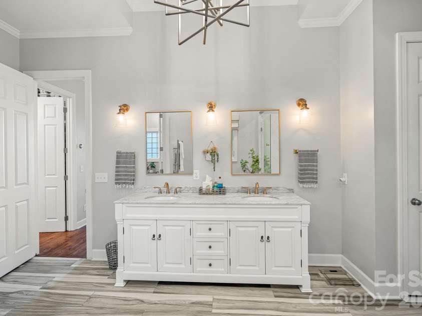 107 Beachview Drive, Mooresville, NC 28117.  MLS# CAR4377535, YatesRealty ID 22019. Renovated spa bath with dual vanities