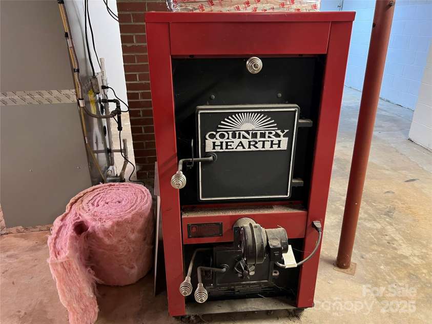 179 Sunnyside Street, Forest City, NC 28043.  MLS# CAR4238466, YatesRealty ID 22026. Extra heat wood burning stove in basement