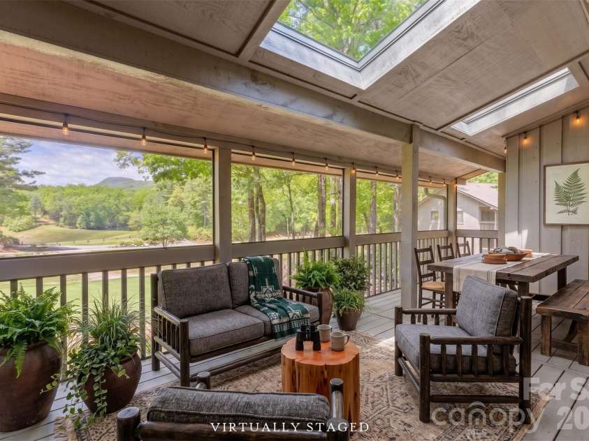 84 Fairway Villas Drive, Sapphire, NC 28774.  MLS# CAR4381824, YatesRealty ID 22026. Virtually staged screened porch