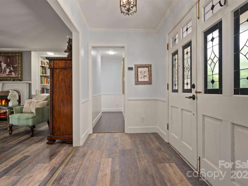 64 Persimmon Hill Drive, Columbus, NC 28722.  MLS# CAR4257157, YatesRealty ID 22038. Living Room w/ hallway to the bedrooms