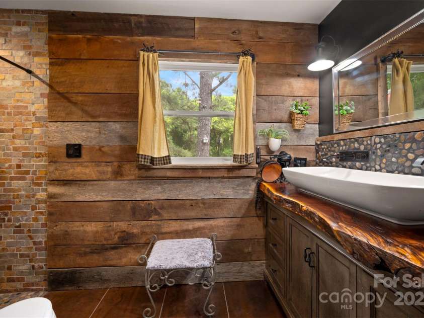 64 Persimmon Hill Drive, Columbus, NC 28722.  MLS# CAR4257157, YatesRealty ID 22038. Master bath w/ wood cabinet w/ from wood on the property.