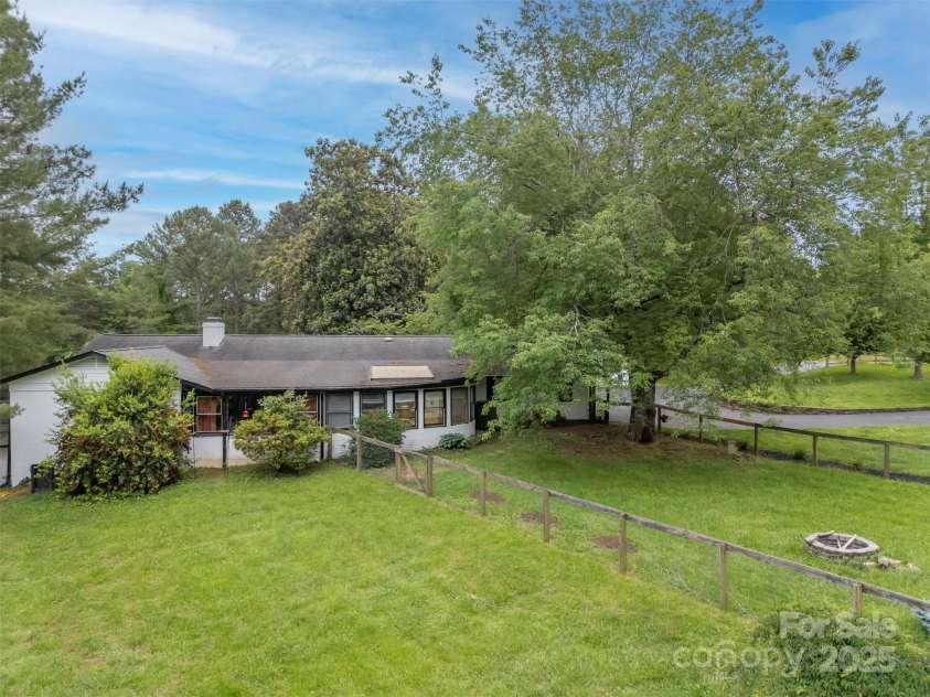 64 Persimmon Hill Drive, Columbus, NC 28722.  MLS# CAR4257157, YatesRealty ID 22038. Side view w/ fencing