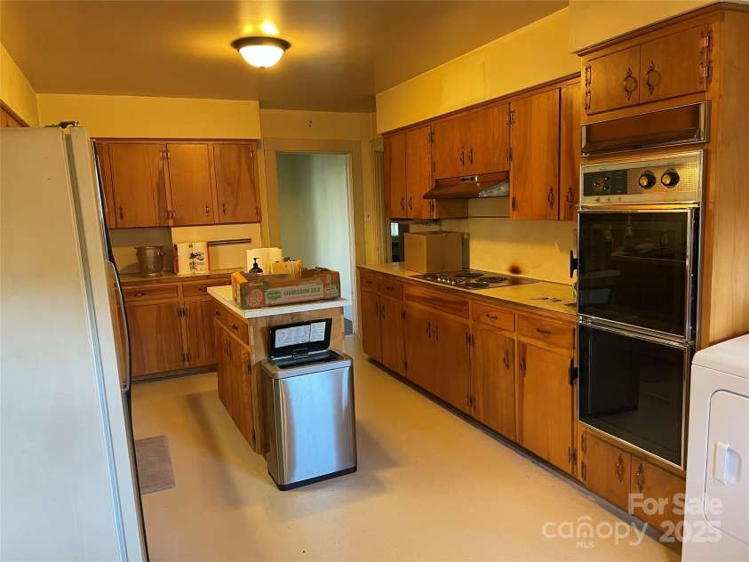 318 Academy Street, Canton, NC 28716.  MLS# CAR4263359, YatesRealty ID 2205. Large galley kitchen with solid wood cabinets