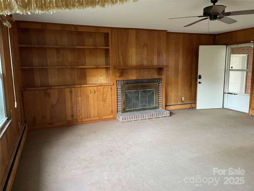 318 Academy Street, Canton, NC 28716.  MLS# CAR4263359, YatesRealty ID 2205. Oversized den, off kitchen has wood burning fireplace.