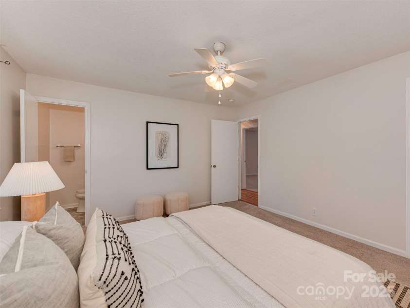 713 Springfield Drive, Concord, NC 28027.  MLS# CAR4269267, YatesRealty ID 22075. Abundant natural light, soft carpeting, and light-toned walls give the primary suite a fresh, airy feel.