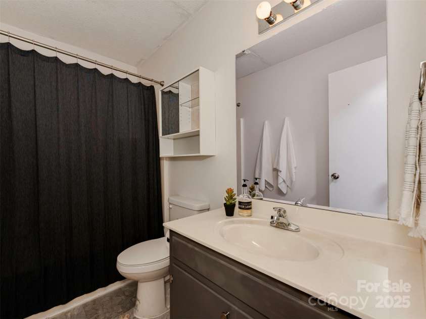 713 Springfield Drive, Concord, NC 28027.  MLS# CAR4269267, YatesRealty ID 22075. Designed for both space and efficiency, the full bath includes thoughtful built-ins and ample storage to keep everything organized.