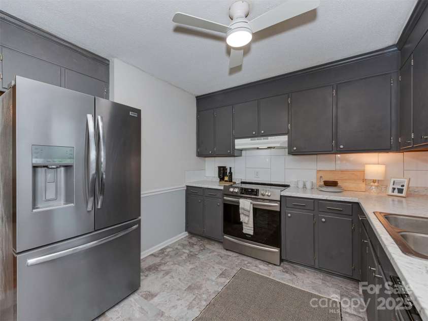 713 Springfield Drive, Concord, NC 28027.  MLS# CAR4269267, YatesRealty ID 22075. Enjoy fresh new flooring in the kitchen, along with sleek stainless steel appliances—including a refrigerator, dishwasher, and electric range.