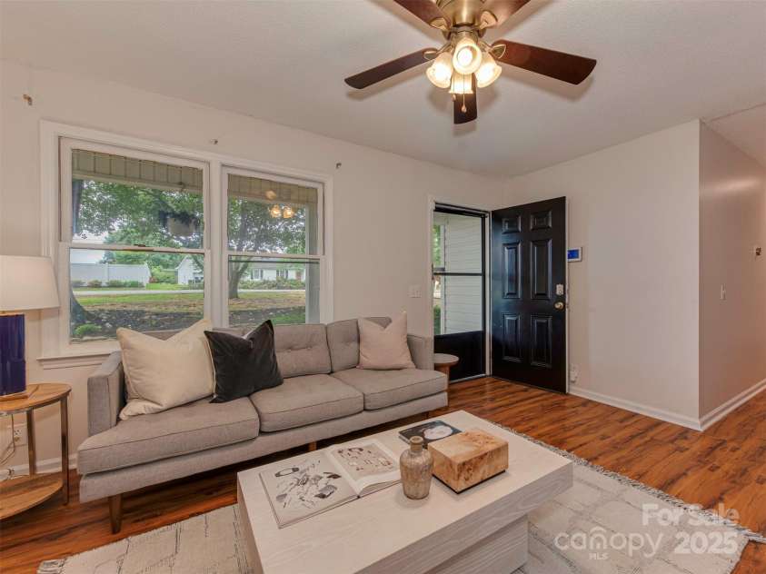 713 Springfield Drive, Concord, NC 28027.  MLS# CAR4269267, YatesRealty ID 22075. Nothing captures the charm of front porch living quite like this open-concept living room, blurring the line between indoor comfort and outdoor charm.