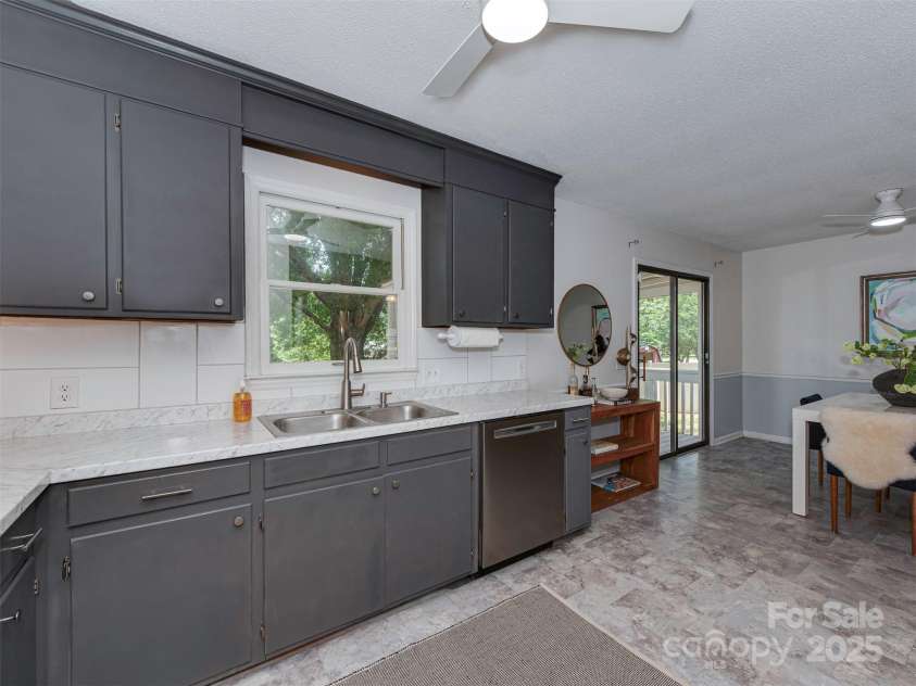 713 Springfield Drive, Concord, NC 28027.  MLS# CAR4269267, YatesRealty ID 22075. Take in peaceful views of the spacious backyard right from your kitchen window.