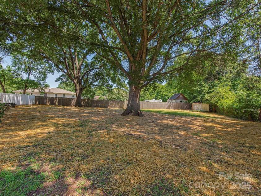 713 Springfield Drive, Concord, NC 28027.  MLS# CAR4269267, YatesRealty ID 22075. The fully fenced backyard offers a private oasis—and a safe, spacious spot for your pets to roam freely and happily.