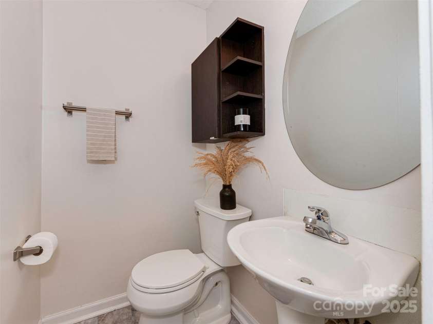 713 Springfield Drive, Concord, NC 28027.  MLS# CAR4269267, YatesRealty ID 22075. The primary bedroom includes a private en-suite half bath for added convenience.