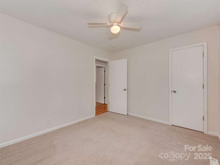 713 Springfield Drive, Concord, NC 28027.  MLS# CAR4269267, YatesRealty ID 22075. The secondary bedrooms are perfectly sized for comfort and flexibility. This one measures 12'x9' and sits conveniently just across the hall from the primary suite.