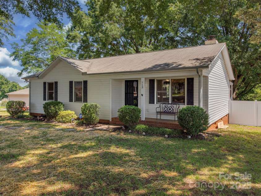 713 Springfield Drive, Concord, NC 28027.  MLS# CAR4269267, YatesRealty ID 22075. This charming ranch includes a cozy, partially covered front porch-perfect for quiet mornings or a relaxed evening outdoors.
