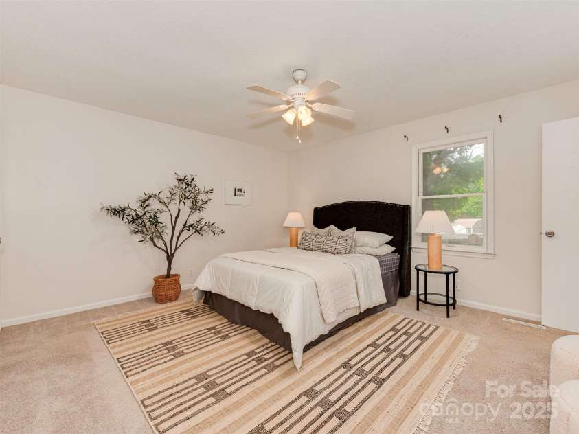 713 Springfield Drive, Concord, NC 28027.  MLS# CAR4269267, YatesRealty ID 22075. Tucked away at the back of the home, the primary bedroom offers peaceful privacy, serene views of the backyard, and ample space to create your own personal retreat.