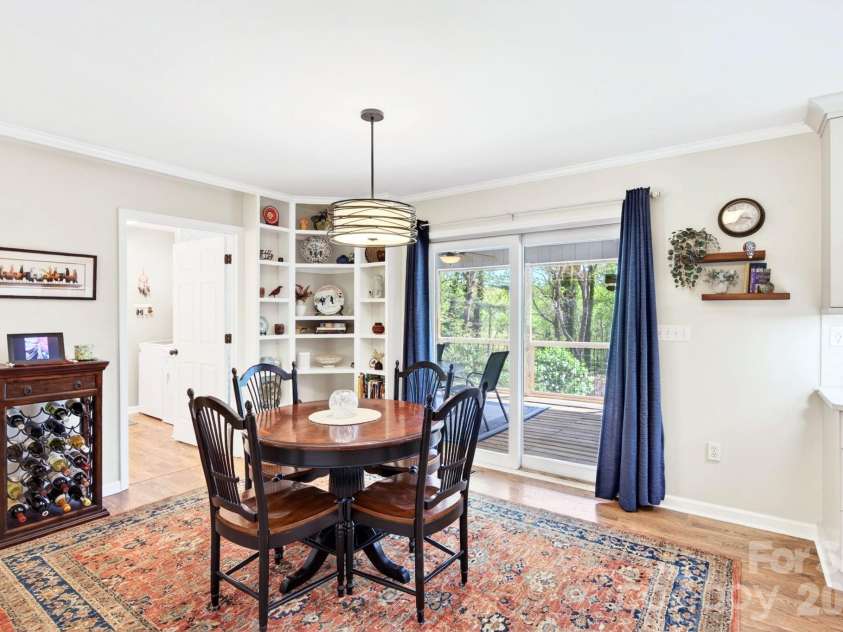 29 Blueberry Lane, Fairview, NC 28730.  MLS# CAR4374304, YatesRealty ID 22087. Bright dining area with statement lighting and built-ins