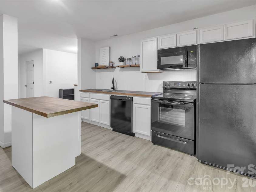 128 Spencer Woods Drive, Dallas, NC 28034.  MLS# CAR4376736, YatesRealty ID 22088. Basement kitchen