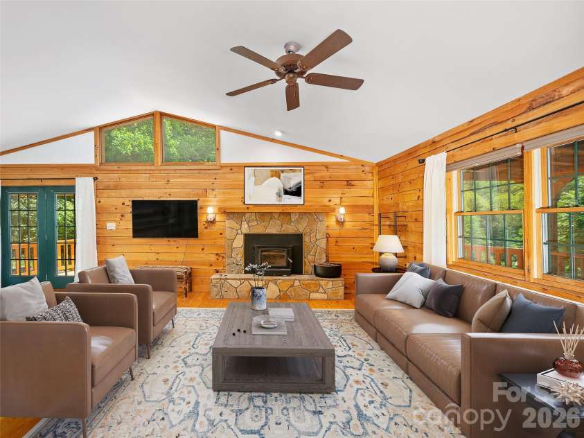 115 Sutton Ridge Road, Burnsville, NC 28714.  MLS# CAR4376173, YatesRealty ID 22099. Living Room with Woodstove Fireplace (Virtually Staged)