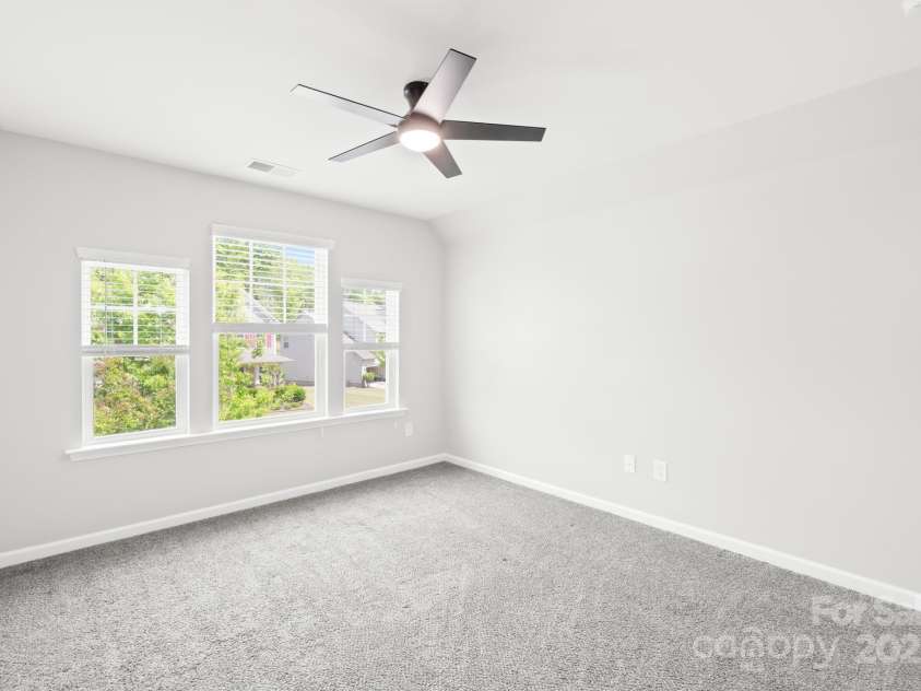 3022 Oakmere Road, Waxhaw, NC 28173.  MLS# CAR4249075, YatesRealty ID 22108. Lots of lighting and new fan in this secondary bedroom.