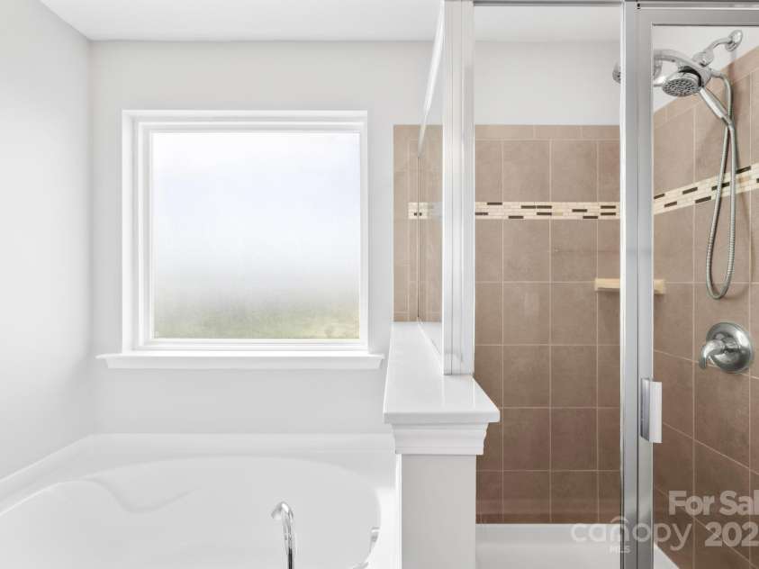 3022 Oakmere Road, Waxhaw, NC 28173.  MLS# CAR4249075, YatesRealty ID 22108. Primary bath features dual vanities, garden tub, walk-in tiled shower, and a huge walk-in closet.