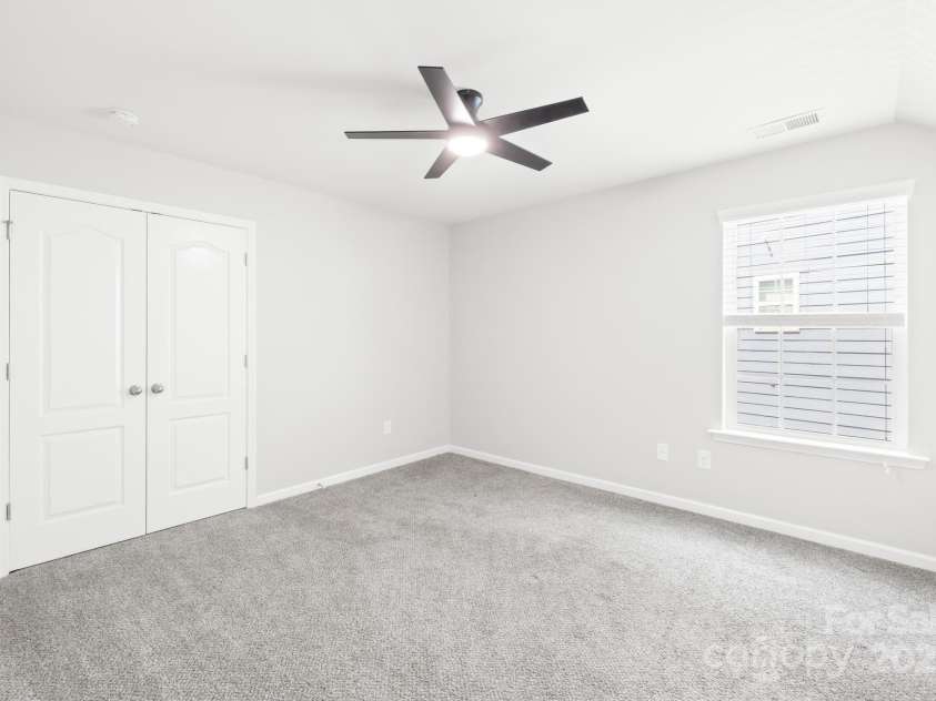 3022 Oakmere Road, Waxhaw, NC 28173.  MLS# CAR4249075, YatesRealty ID 22108. Third upstairs bedroom with fan and large closet.