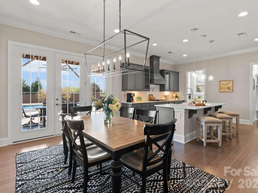 1053 Harlow's Crossing Drive, Matthews, NC 28104.  MLS# CAR4353232, YatesRealty ID 22111. Bright dining space with access to outdoor living