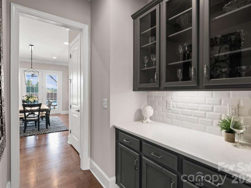 1053 Harlow's Crossing Drive, Matthews, NC 28104.  MLS# CAR4353232, YatesRealty ID 22111. Butler’s pantry with additional storage and space