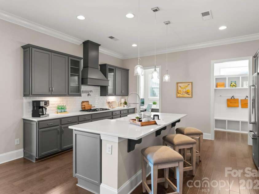 1053 Harlow's Crossing Drive, Matthews, NC 28104.  MLS# CAR4353232, YatesRealty ID 22111. Chef’s kitchen with oversized island and seating