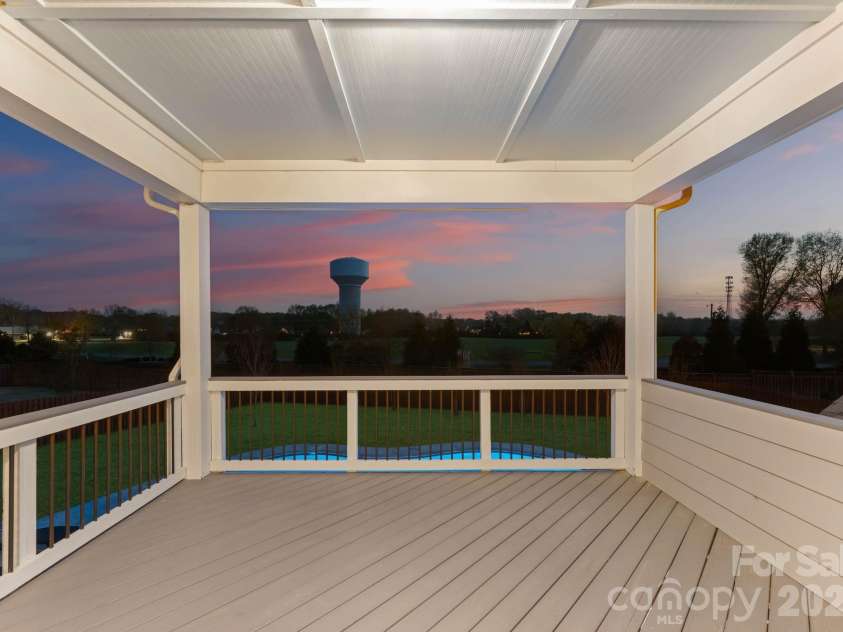 1053 Harlow's Crossing Drive, Matthews, NC 28104.  MLS# CAR4353232, YatesRealty ID 22111. Covered balcony with elevated views of backyard and pool